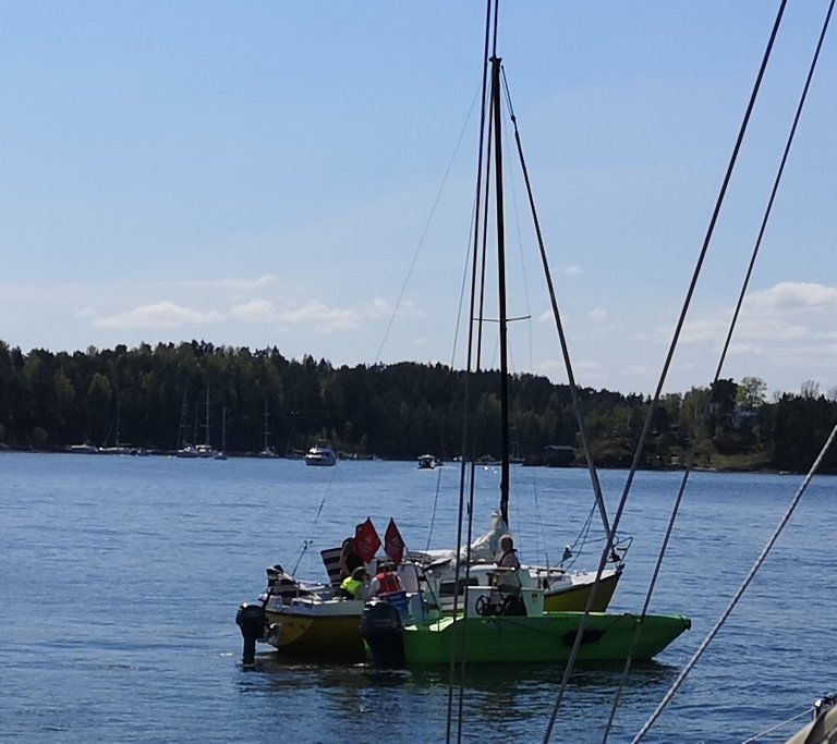 An ice cream seller serving a yellow sail boat