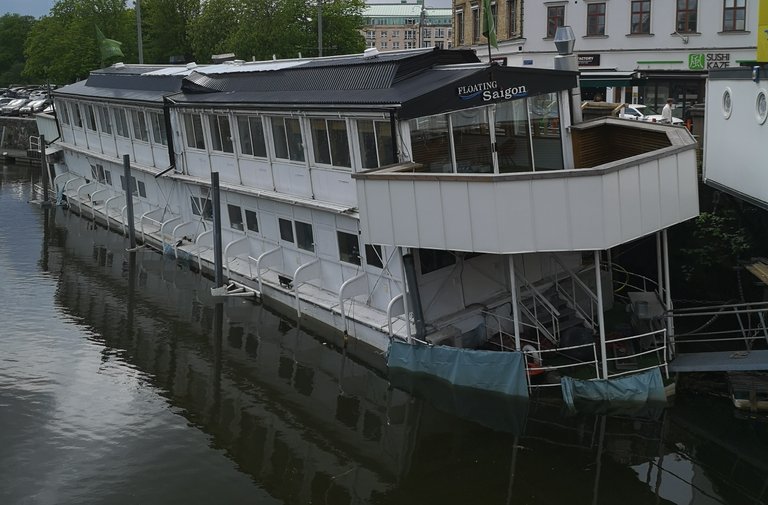 A floating resturant, with the name "Floating Saigon" is sinking