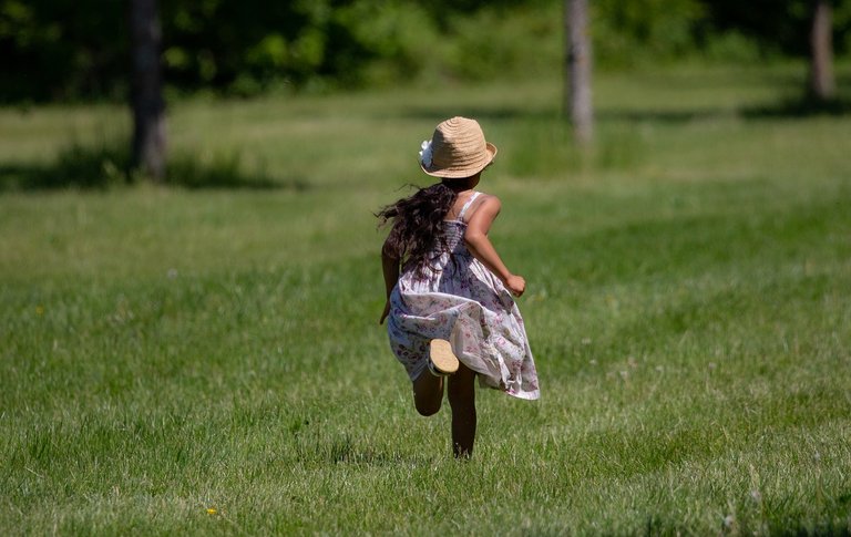 Child running through grass