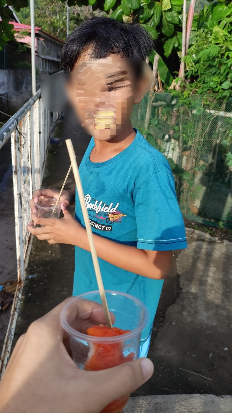 Kid eating kwek-kwek.jpg