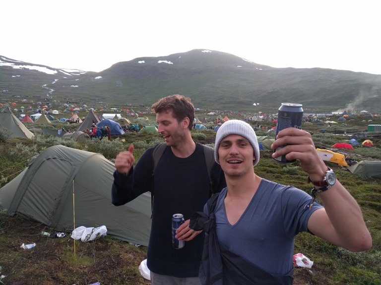 Picture of guys and festival in the background