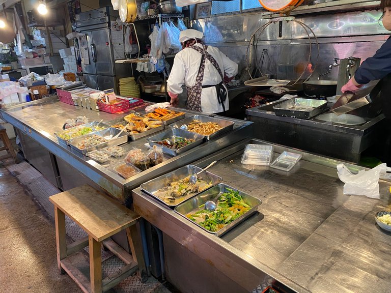 Vegetables and fried food just beside the rice corner