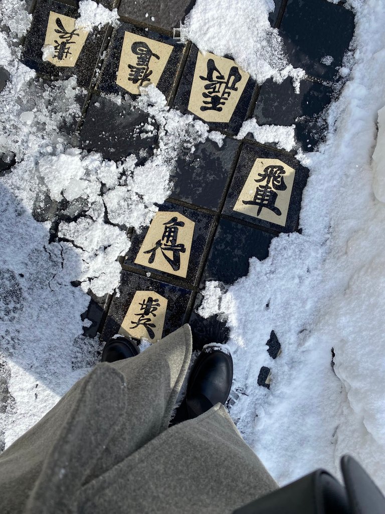 Shogi pieces on the sidewalk