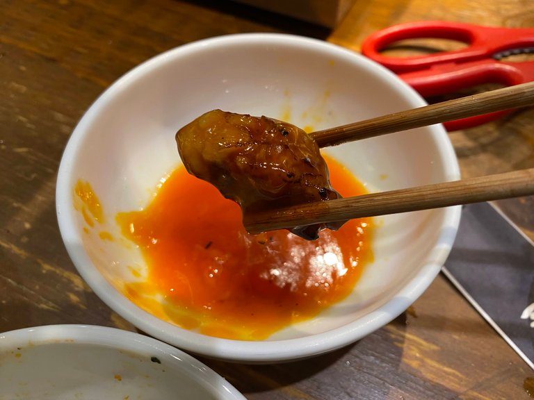 Yakiniku dipped in soy sauce and coated with raw egg