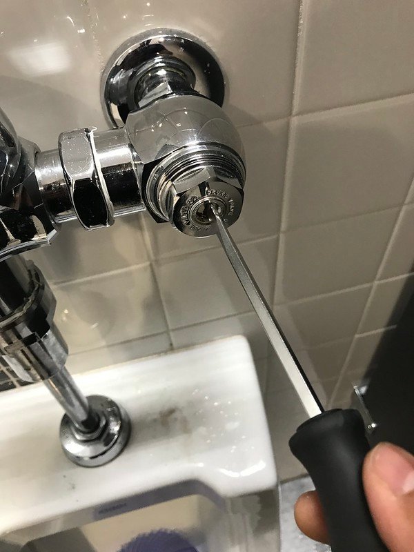 Use a screwdriver to turn water flow on/off