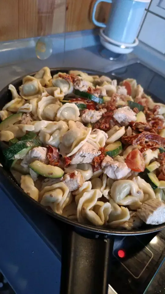 Tortellini with zucchini, turkey, dry and fresh tomatoes, garlic and cream.