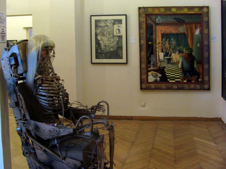 My work “The Beast of Babylon” in the Phantasten Museum, Vienna. It was on loan to the museum for several years. Foreground is a sculpture by Curt Stenvert, next to my drawing is a painting by Jehan Calvus. The Museum at the Palais Palffy in Vienna has been closed many years ago. 