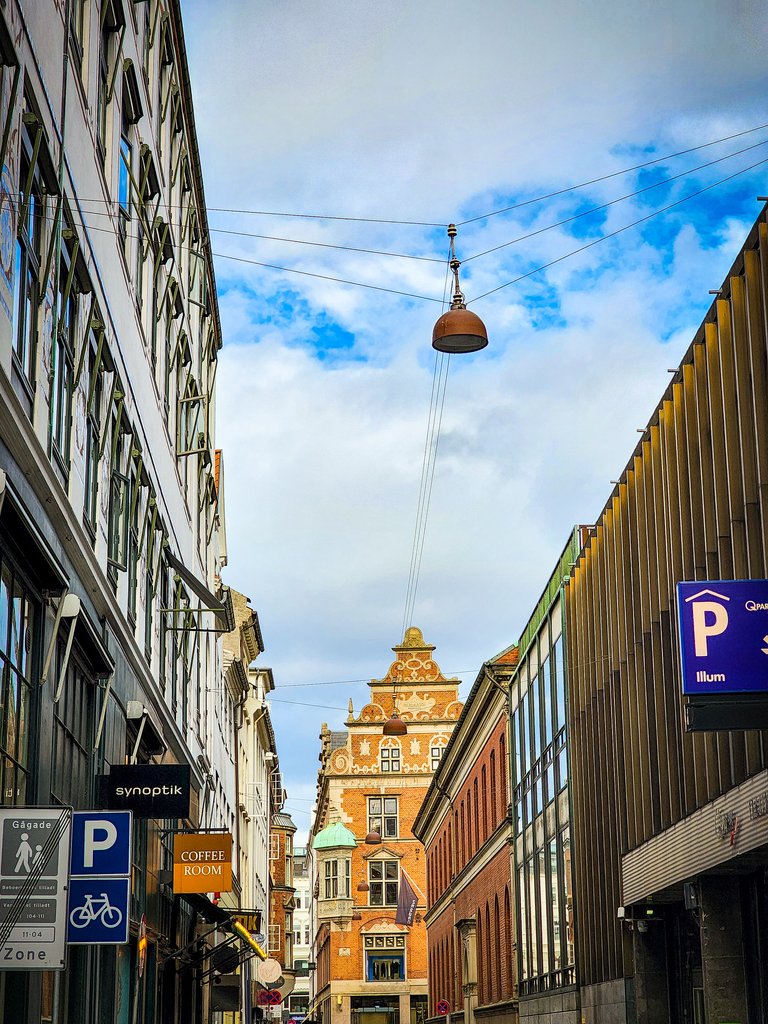 Street view looking up at Copenhagen's historic architecture with blue sky