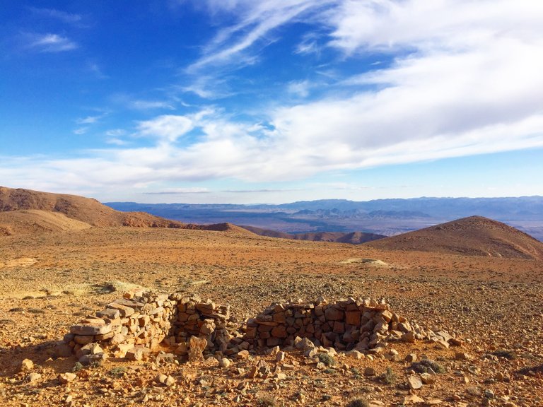 Disused mining shelters and tailing piles dot the landscape.