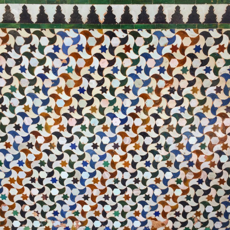 Intricate and colourful tessellation of tiles that purportedly influenced M. C. Esher's work on the subject. 