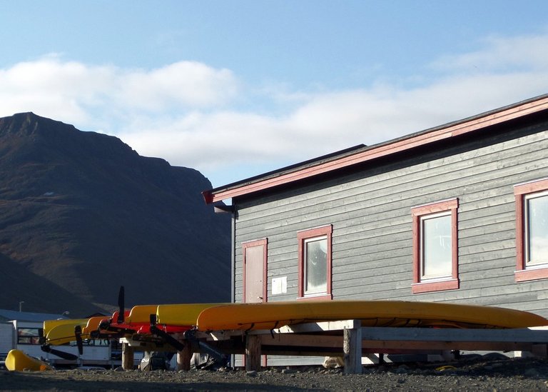 Kayaks stored in a row in Longyearbyen.