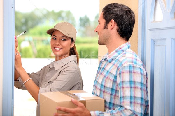 2188512_stock-photo-man-receiving-package-from-a-delivery-girl.jpg