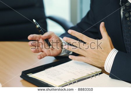 stock-photo-a-businessman-with-pen-doing-gesticulation-8883310.jpg