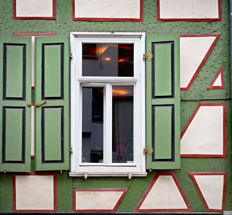 Window in a green colored half-timbered house