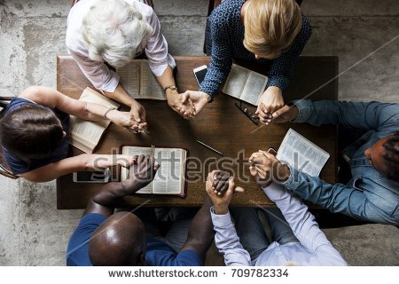 stock-photo-group-of-people-holding-hands-praying-worship-believe-709782334.jpg