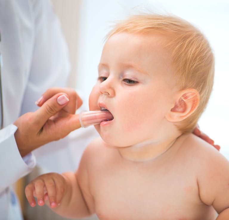 baby-with-finger-cleaning-massaging-gums.jpg