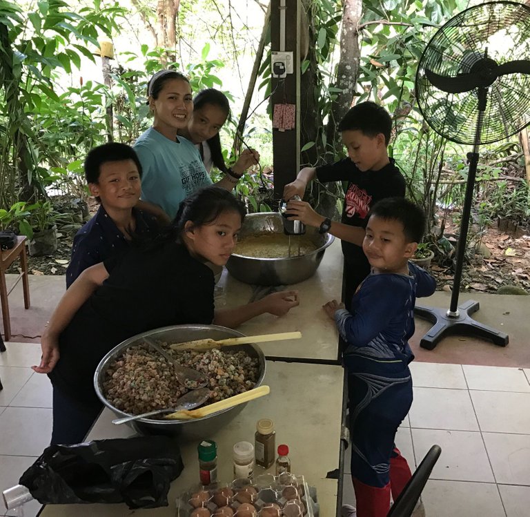 Jen is assisted by her nieces and nephews in cake baking.jpg