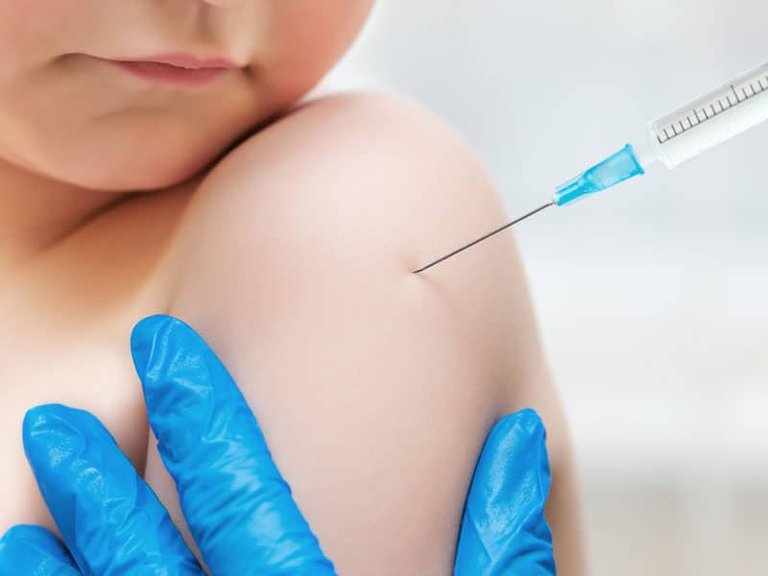 Boy-getting-vaccine-blue-gloves.jpg