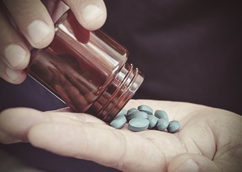 drugabuse-shutterstock312839624-pouring-blue-pills-in-hand.jpg