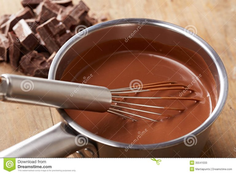preparing-hot-chocolate-pot-wooden-table-35541033.jpg