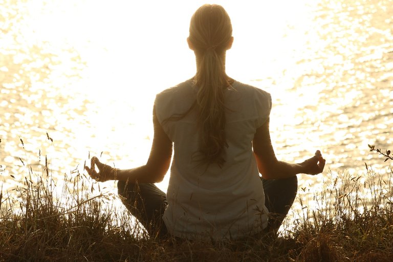 woman meditate water.jpg