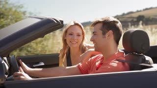 young-couple-driving-convertible-car-in-countryside_mkzalow9__S0000.jpg