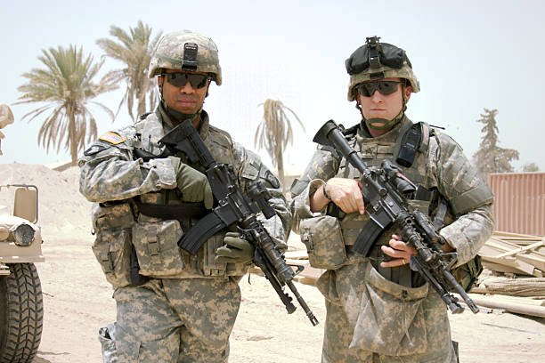 two-soldiers-posing-on-camera-in-the-middle-east-picture-id157186552.jpeg