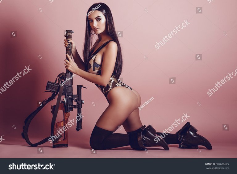 stock-photo-hot-and-sexy-brunette-girl-with-a-gun-on-a-pink-background-beautiful-girl-in-the-army-587638625.jpg