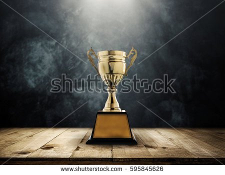 stock-photo-champion-golden-trophy-placed-on-wooden-table-with-dark-background-copy-space-ready-for-your-design-595845626.jpg