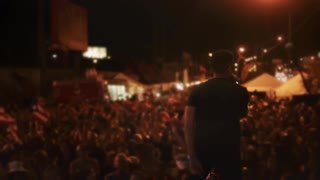 man-singing-on-stage-in-front-of-crowd-of-people_vk9vc3dm__S0000.jpg