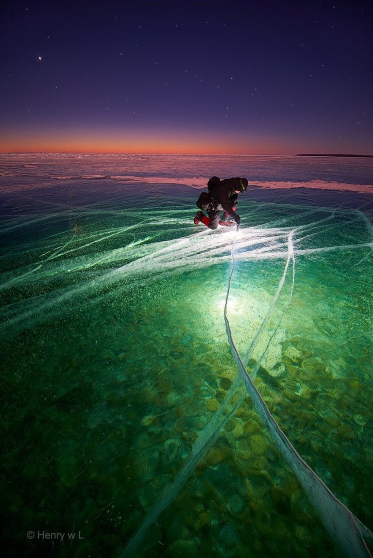 Man with Flashlight on Ice creates Beauty.jpg