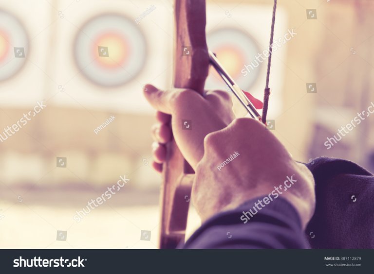stock-photo-image-of-archer-holds-his-bow-aiming-at-a-target-387112879.jpg