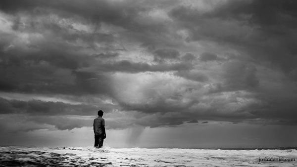 man-beach-rain-clouds.jpg