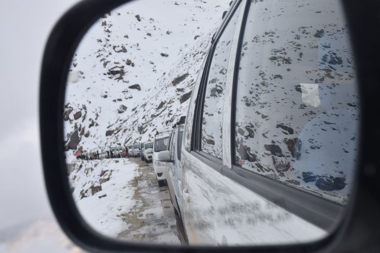 Mirrored image of vehicles stuck in snow