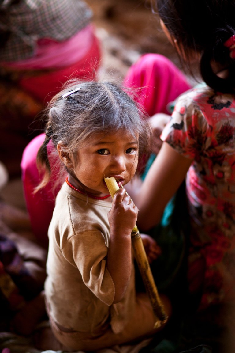 IMG_5686 a small girl enjoying sugarcane.jpg