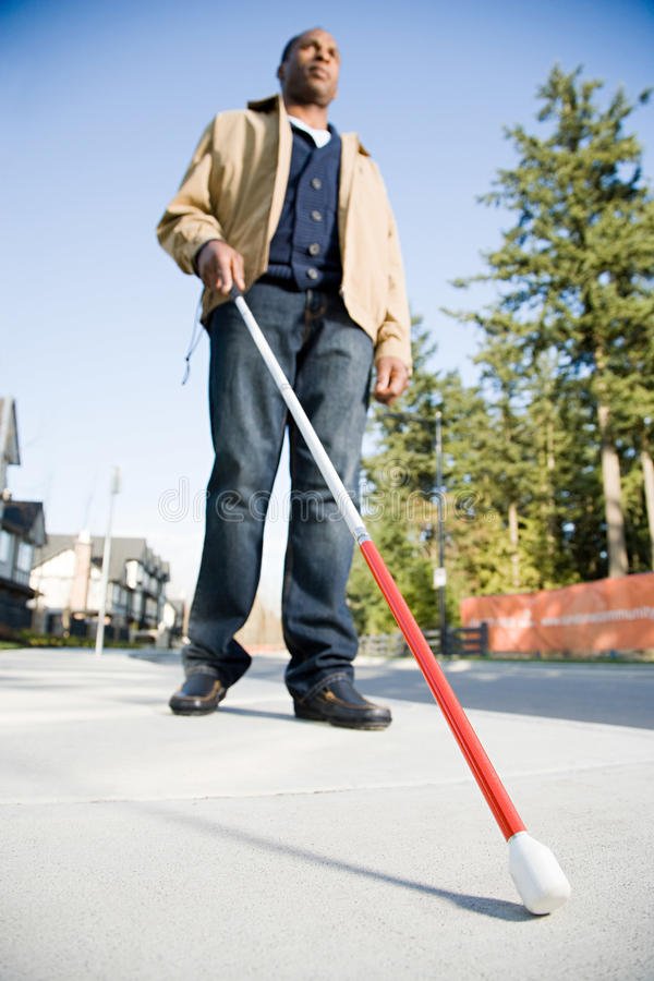 blind-man-using-walking-stick-62557749.jpg