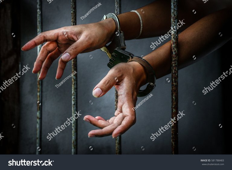 stock-photo-prisoner-in-prison-with-handcuff-581788483.jpg