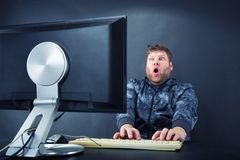 man-sitting-desk-looking-computer-screen-surprised-monitor-40149487.jpg