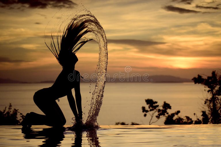 sexy-woman-hair-flipping-bikini-sunset-silhouette-edge-infinity-pool-over-looking-ocean-mountains-89949092.jpg