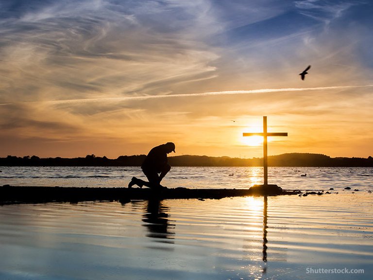 man-kneeling-prayer-cross-water.jpg