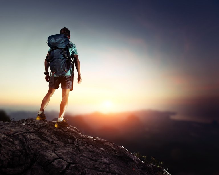 hiker-standing-on-mountain-top.jpg