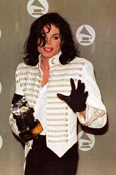 pop-superstar-michael-jackson-holds-his-grammy-legend-award-and-waves-picture-id52030000 (1).jpg