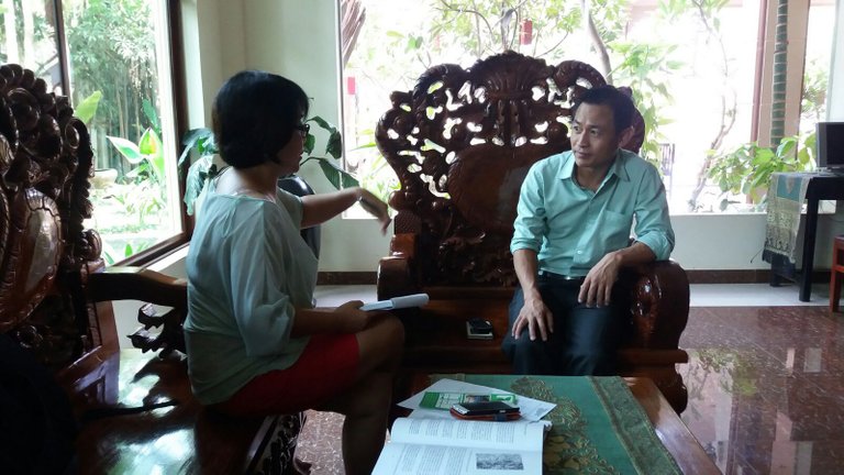 Chan being interviewed about how he survived during the khmer Rouge period at his hotel in Siem Reap Cambodia.jpg