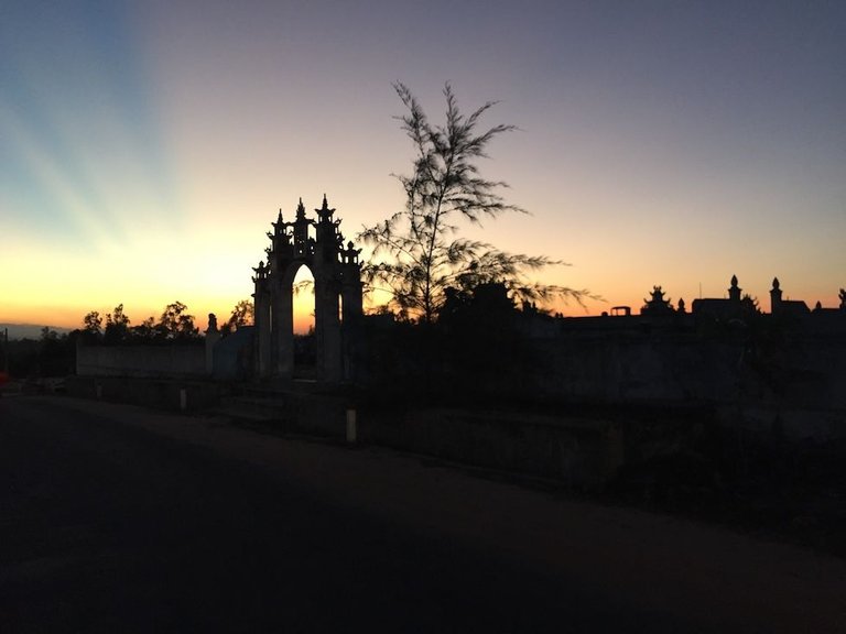 dong hoi sunset through graveyard.JPG