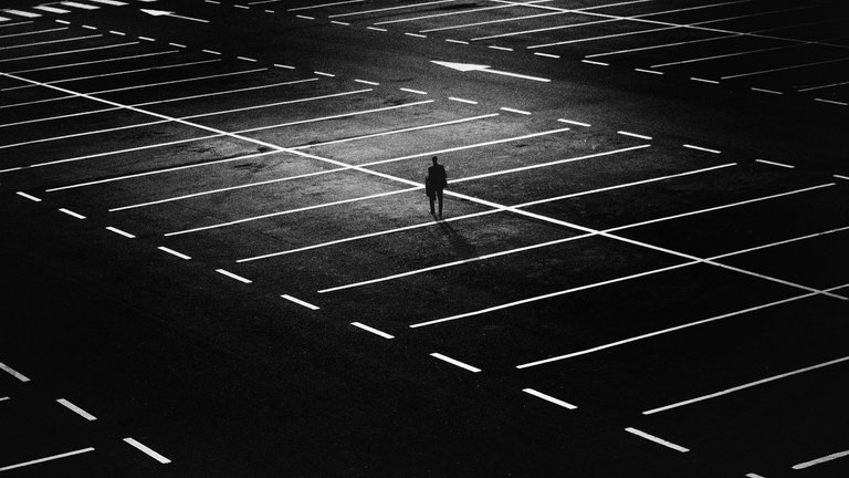 dark-empty-parking-lot-one-man.jpg