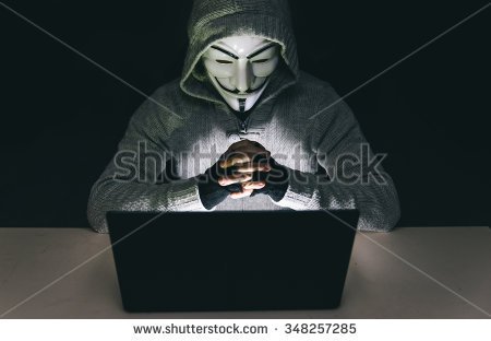 stock-photo-milan-italy-december-rd-man-with-anonymous-association-mask-working-on-the-laptop-348257285.jpg