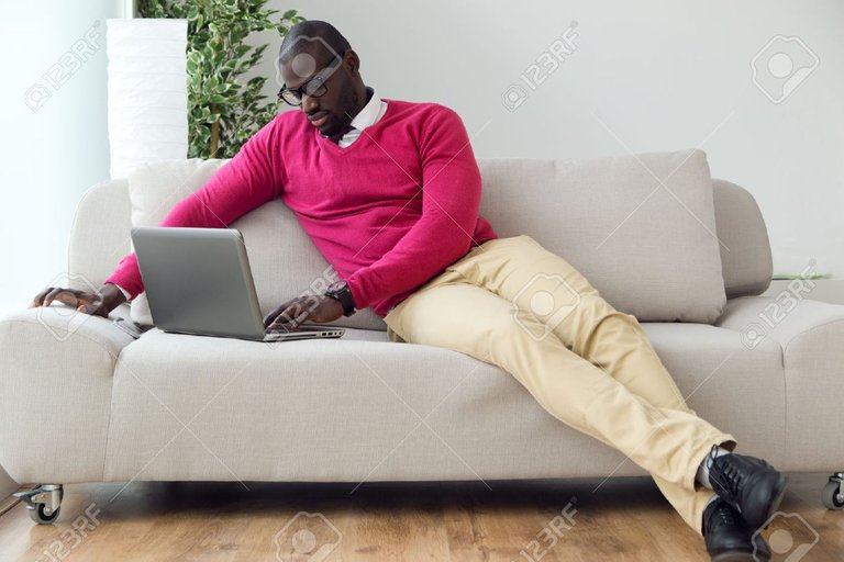 51873503-Portrait-of-handsome-young-man-working-with-his-laptop-at-home--Stock-Photo.jpg