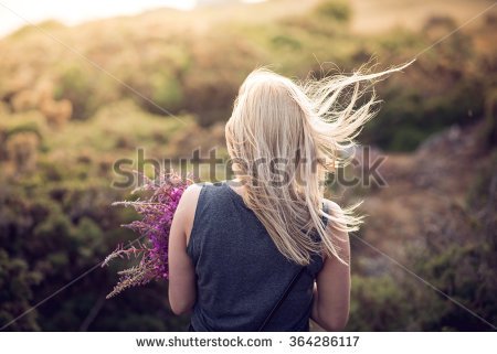 stock-photo-blonde-girl-walks-towards-sunset-holding-bunch-of-wild-flowers-364286117.jpg