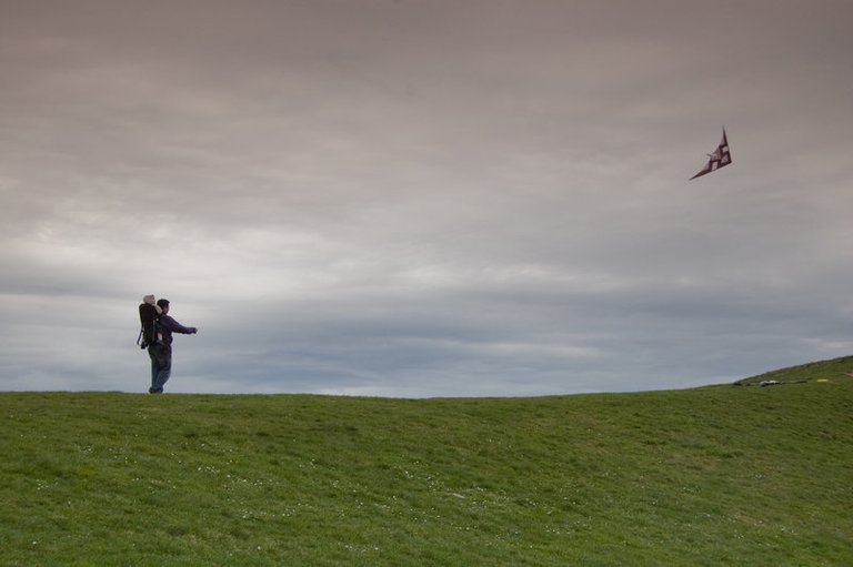 man_and_son_fly_kite_on_hill_by_happeningstock.jpg