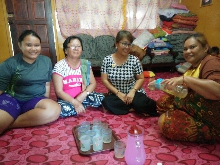 Irene (left) with her aunty Neggie and mum Kambai (right) serving air Tuak to visitors.jpg